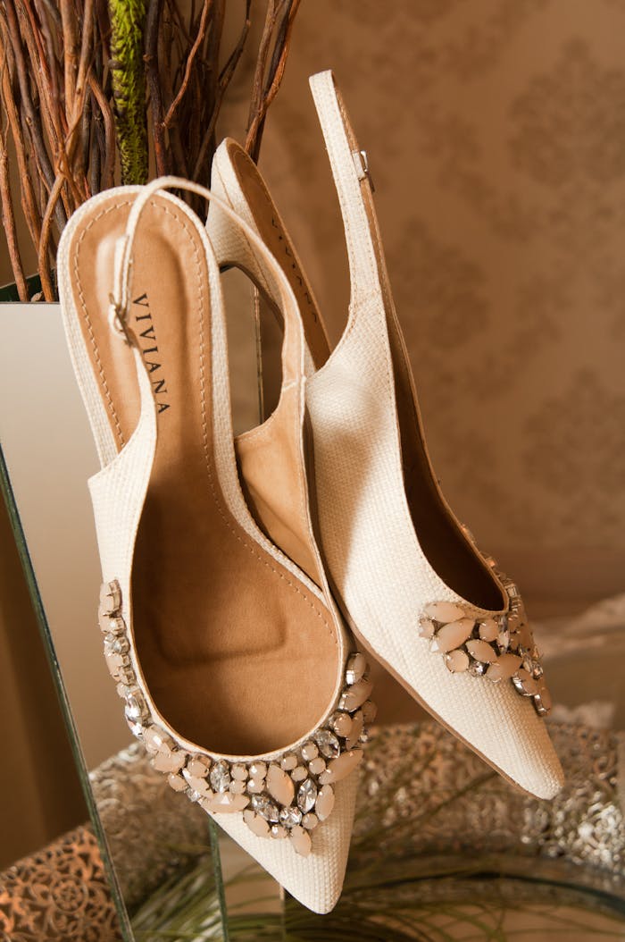 Stylish white high heel shoes adorned with rhinestones, perfect for formal occasions.