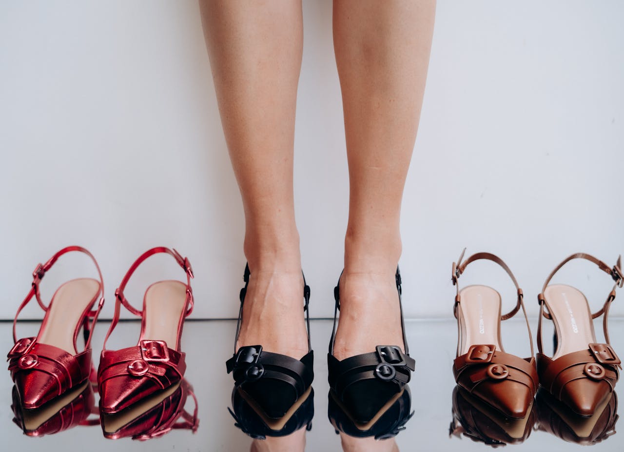 Close-up of women's legs with stylish heels and colorful shoes on display.